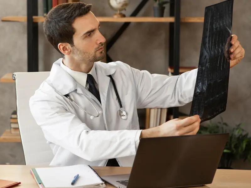 Senior cardiologist examining heart reports at IDMH Patna.