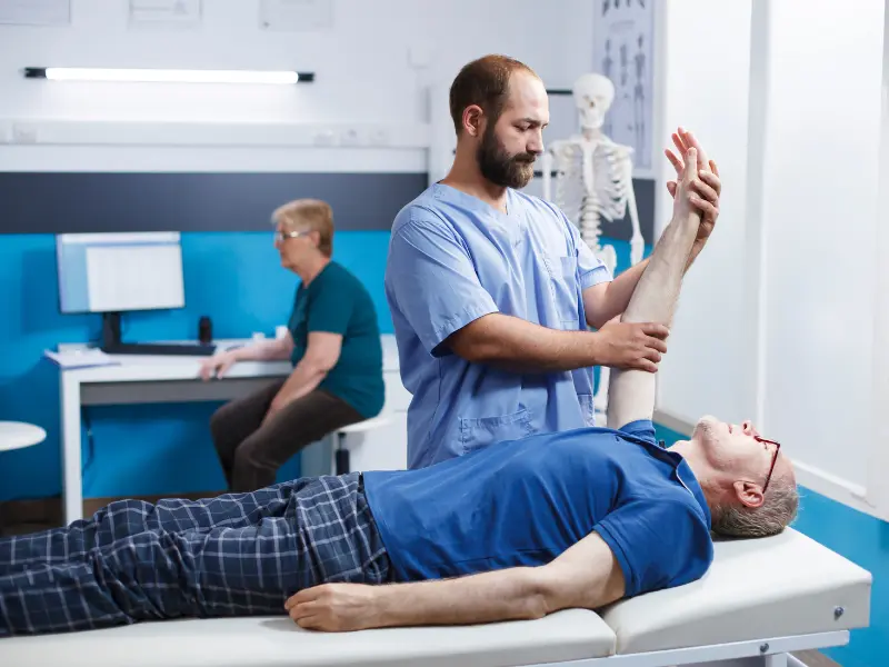 Senior orthopaedic surgeon explaining X-ray to a patient at IDMH Patna.