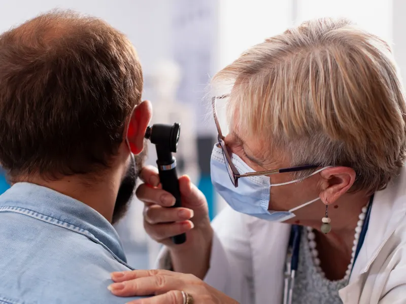 ENT doctor checking a patient's ear in a Patna hospital.
